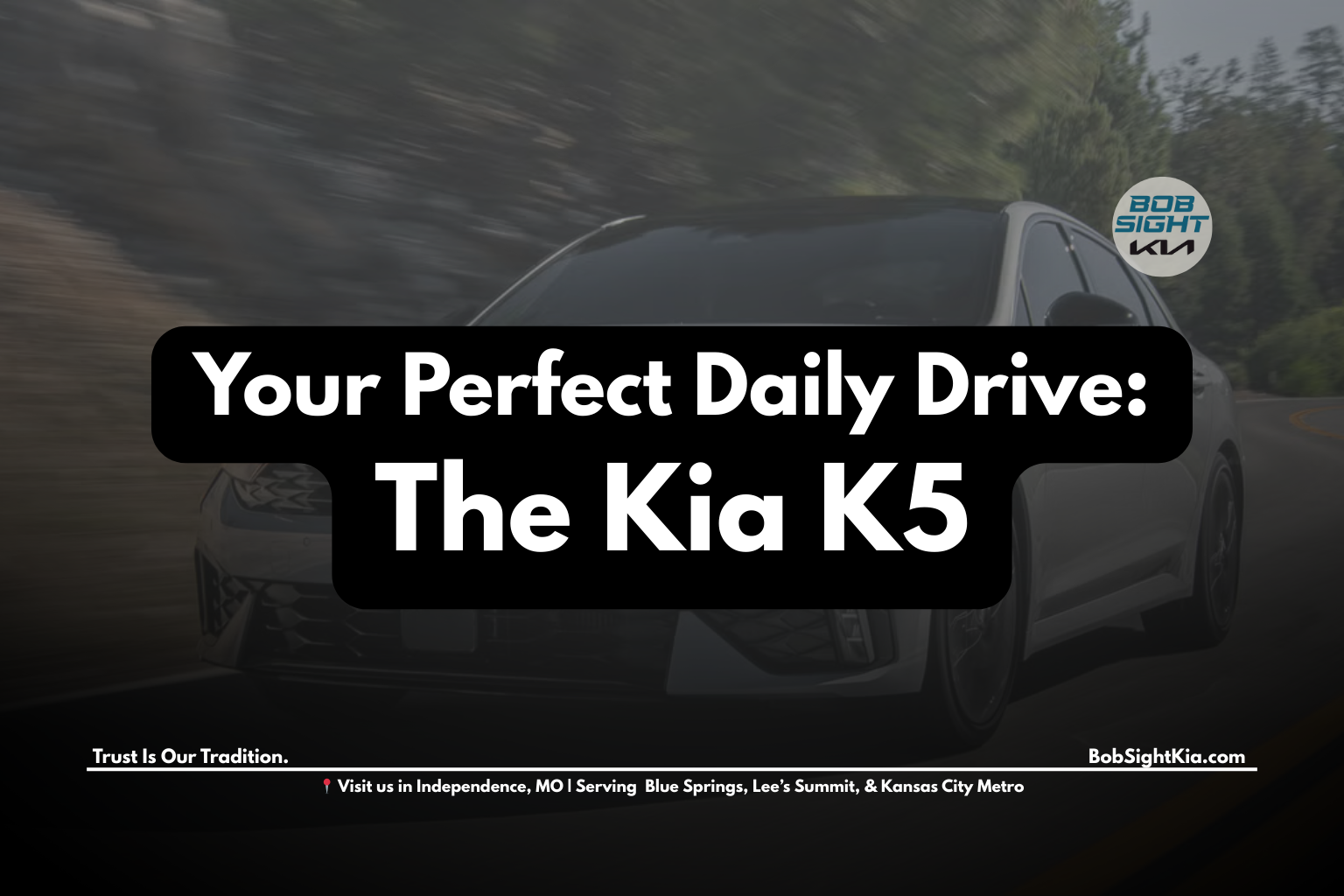 2025 Kia K5 sedan driving in Kansas City highlighting commuter-friendly design at Bob Sight Kia Independence MO