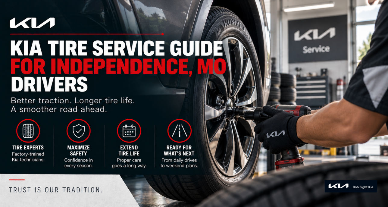 Kia service technician inspecting tire tread at Bob Sight Kia in Independence, Missouri