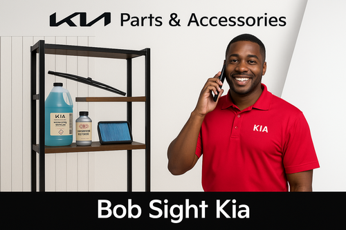 Bob Sight Kia parts specialist on the phone with Kia windshield wiper, air filter, and fluids displayed in background at Independence, MO dealership